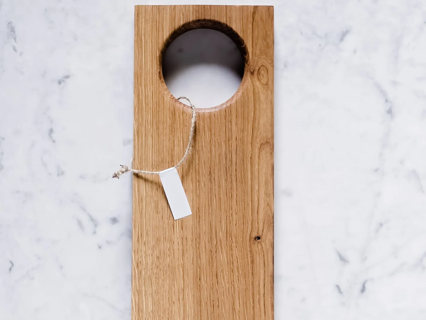 A rectangular wooden cutting board on a marble counter.