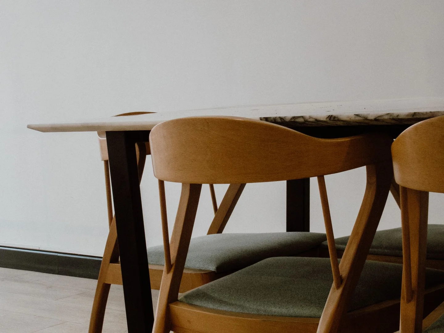 Wooden dining chairs arranged around a table.
