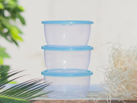 Reusable food containers stacked with matching blue lids.