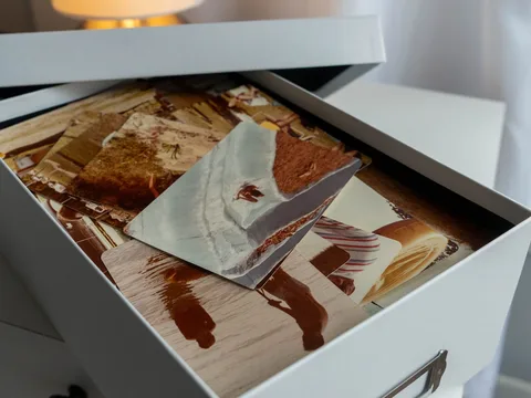 An open keepsake box filled with old photographs.