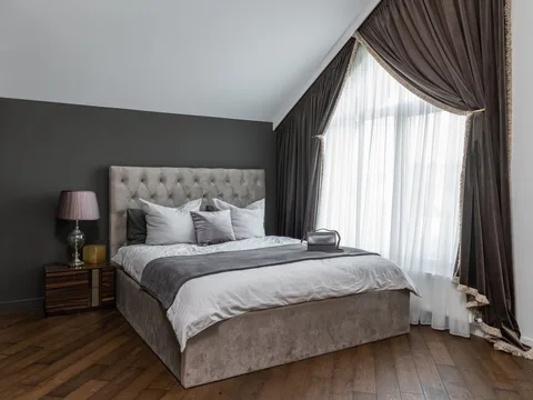 A made bed with a duvet and pillows.