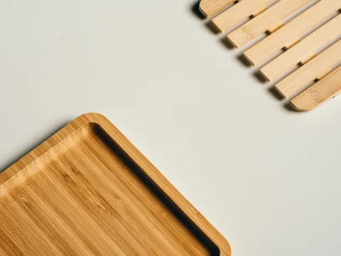 Wooden serving trays on a white surface.